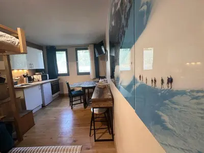 a kitchen with a large aquarium in the middle of a room at Nouveau Refuge de l aiguille in Chamonix-Mont-Blanc