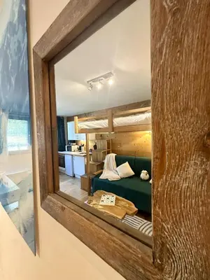 a mirror reflection of a bedroom with a bunk bed at Nouveau Refuge de l aiguille in Chamonix-Mont-Blanc