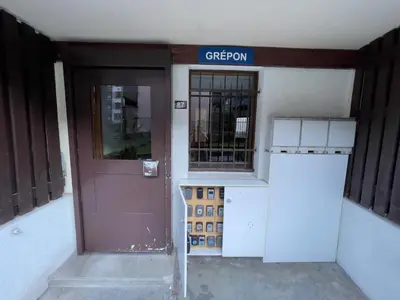 an entrance to a building with a brown door at Nouveau Refuge de l aiguille in Chamonix-Mont-Blanc