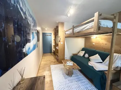 a living room with a couch and bunk beds at Nouveau Refuge de l aiguille in Chamonix-Mont-Blanc