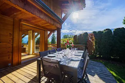a kitchen with wooden cabinets and a counter top at Chalet des Sommets in Combloux