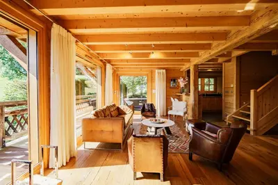 a table and chairs on a wooden deck at Chalet des Sommets in Combloux