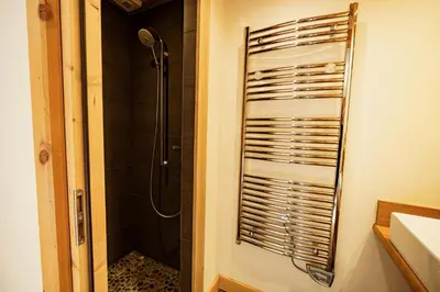 a bathroom with a shower and a sink and a shower at Chalet des Sommets in Combloux