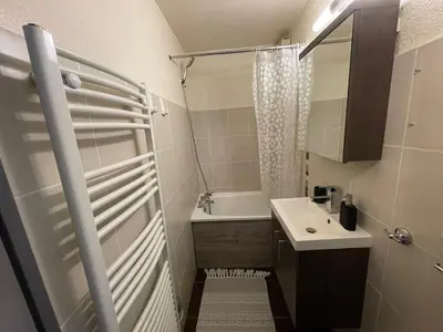 a small bathroom with a shower and a sink at Downtown Chamonix Studio & Stunning Mountain View in Chamonix-Mont-Blanc