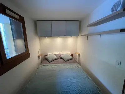a small bedroom with a bed in the corner at Downtown Chamonix Studio & Stunning Mountain View in Chamonix-Mont-Blanc