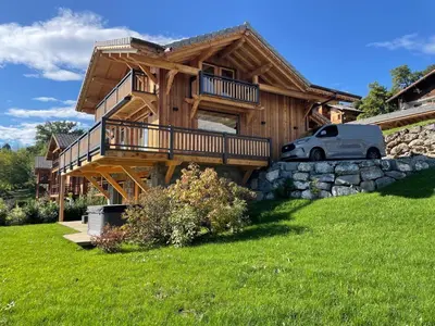 a house with a car parked in front of it at Chalet Le M - Adults only - Standing - Samoëns Grand-Massif in Samoëns