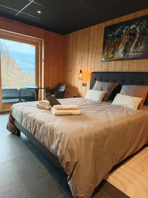 a bedroom with a large bed with towels on it at Chalet Le M - Adults only - Standing - Samoëns Grand-Massif in Samoëns