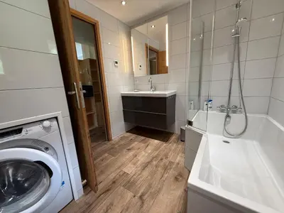 a bathroom with a washing machine and a sink at Apartment in Chamonix in Chamonix-Mont-Blanc