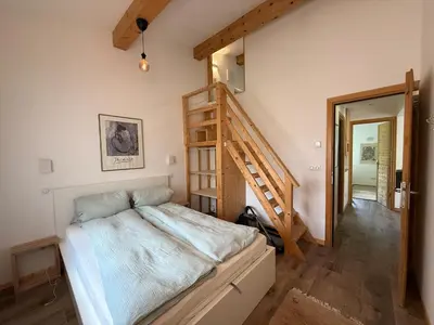 a bedroom with a bed and a wooden ladder at Apartment in Chamonix in Chamonix-Mont-Blanc