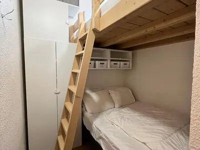 a bunk bed in a small room with a bunk bed in a bedroom at Studio cosy au centre de Samoëns, animaux acceptés - FR-1-624-183 in Samoëns