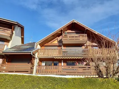 a large wooden house with a gambrel at Studio cosy au centre de Samoëns, animaux acceptés - FR-1-624-183 in Samoëns