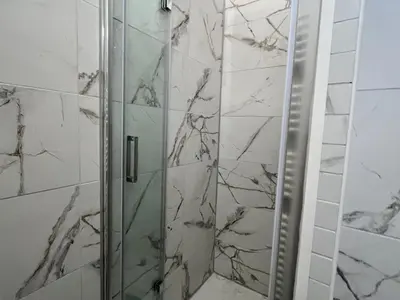 a shower with a glass door in a bathroom at Studio cosy au centre de Samoëns, animaux acceptés - FR-1-624-183 in Samoëns