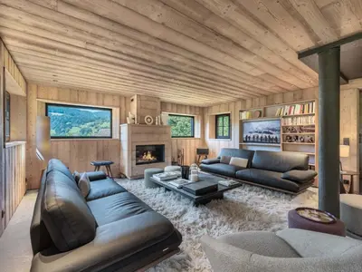 a living room with a couch and a fireplace at Chalet calme à Megève - 4 chambres, proche centre, parking inclus - FR-1-569-201 in Megève