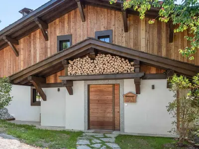 a house with a pile of fire wood on top of it at Chalet calme à Megève - 4 chambres, proche centre, parking inclus - FR-1-569-201 in Megève