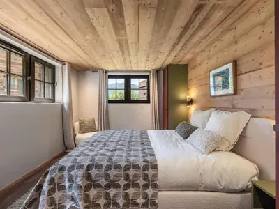 a bedroom with a large bed in a room at Chalet calme à Megève - 4 chambres, proche centre, parking inclus - FR-1-569-201 in Megève