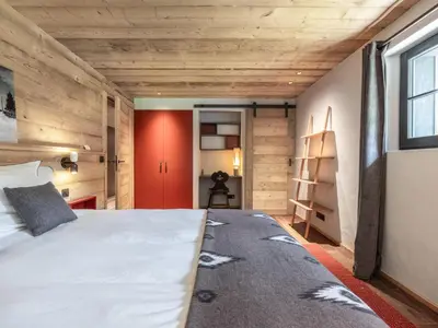 a bedroom with a bed and a red door at Chalet calme à Megève - 4 chambres, proche centre, parking inclus - FR-1-569-201 in Megève