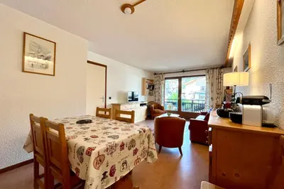 a room with a table and a living room at Cœur Combloran in Combloux