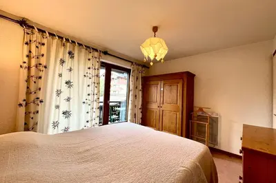 a bedroom with a large bed and a window at Cœur Combloran in Combloux