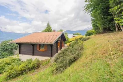 a small house on the side of a hill at L'Écrin des Anges Chalet cosy, Ski et Vue in Combloux
