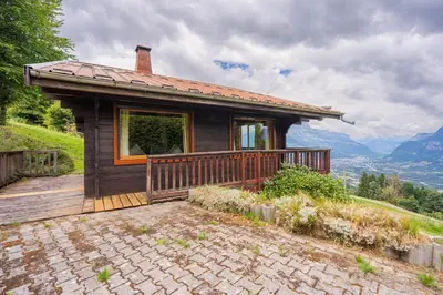 a small house with a deck on a mountain at L'Écrin des Anges Chalet cosy, Ski et Vue in Combloux