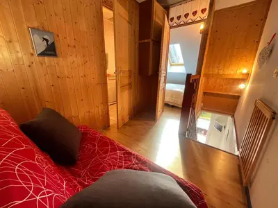 a room with a red bed in a room at Charmant T2 Mezzanine au Centre de Samoëns avec Balcon, WIFI - FR-1-624-182 in Samoëns