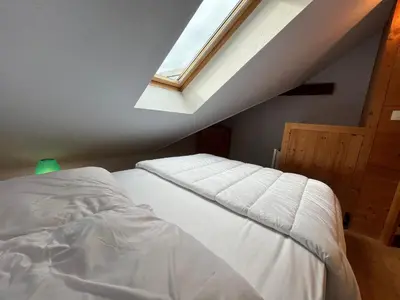 a bedroom with a bed and a window at Charmant T2 Mezzanine au Centre de Samoëns avec Balcon, WIFI - FR-1-624-182 in Samoëns
