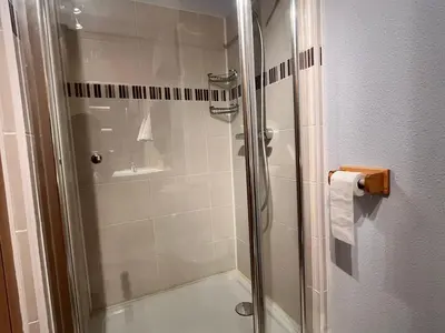 a bathroom with a shower with a glass door at Charmant T2 Mezzanine au Centre de Samoëns avec Balcon, WIFI - FR-1-624-182 in Samoëns