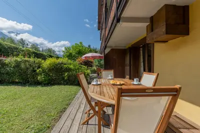 a couple of chairs sitting in the snow at Appartement Les Capucins jardin - Happy Rentals in Chamonix-Mont-Blanc