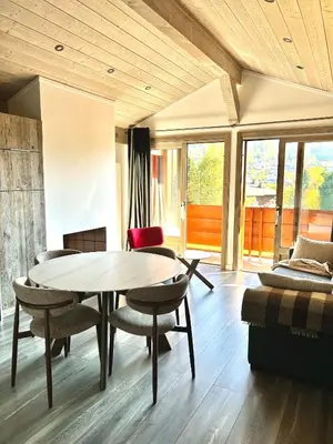 a living room with a table and chairs at Séjour lumineux avec vue sur les cimes in Megève