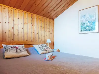 two beds in a room with wooden ceilings at Holiday Home Les Chalets de La Combe by Interhome in Mémontel