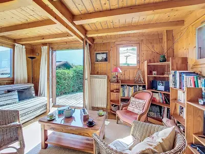 a living room filled with furniture and a wooden ceiling at Holiday Home Les Chalets de La Combe by Interhome in Mémontel