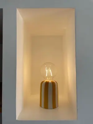 a yellow and white perfume bottle in a box at Studio cosy & rénové, à deux pas de la gare in Sallanches