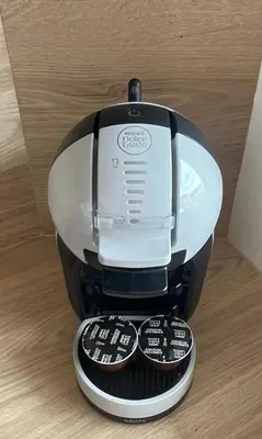 a coffee maker with three remote controls on a table at Studio cosy & rénové, à deux pas de la gare in Sallanches