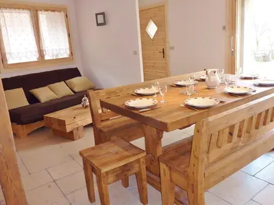 a living room with a wooden table and a couch at Chalet confortable pour 10 pers à Samoëns avec parking et terrasse - FR-1-815-47 in Samoëns