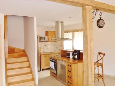 a kitchen with a staircase leading up to a stair case at Chalet confortable pour 10 pers à Samoëns avec parking et terrasse - FR-1-815-47 in Samoëns