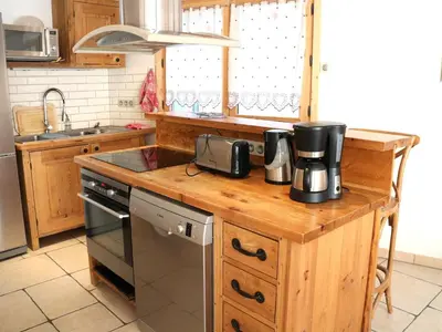 a kitchen with a wooden counter top with a coffee maker at Chalet confortable pour 10 pers à Samoëns avec parking et terrasse - FR-1-815-47 in Samoëns