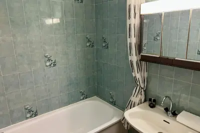 a bathroom with a white tub and a sink at Charming apartment in Chamonix in Chamonix-Mont-Blanc