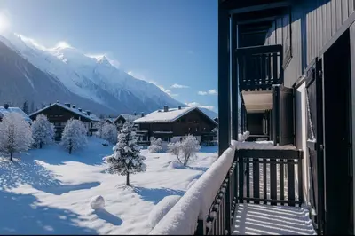 a house covered in snow in front of a mountain at Charming apartment in Chamonix in Chamonix-Mont-Blanc