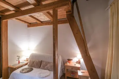 a bedroom with a bed and two night stands at Charming apartment in Chamonix in Chamonix-Mont-Blanc
