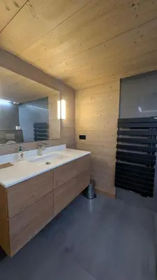 a bathroom with a sink and a large mirror at Le Chalet MontBlanc in Bionnay