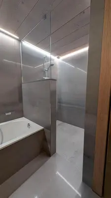 a bathroom with a bath tub and a sink at Le Chalet MontBlanc in Bionnay