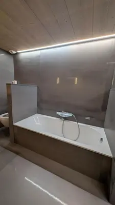 a white bath tub in a room with a toilet at Le Chalet MontBlanc in Bionnay