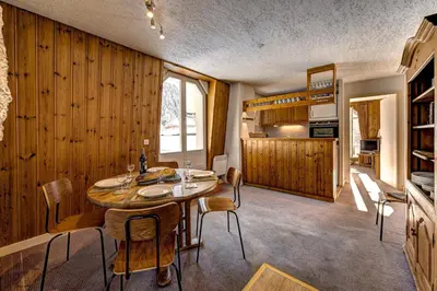 a kitchen and dining room with a table and chairs at Hyper central apartment with rooftop in Chamonix-Mont-Blanc