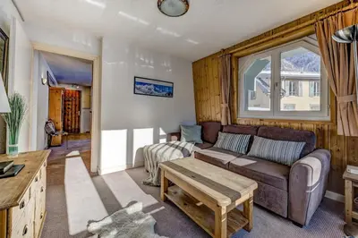 a kitchen with wooden cabinets and a wooden counter top at Hyper central apartment with rooftop in Chamonix-Mont-Blanc