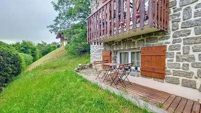 a table and chairs sitting outside of a building at 1 Farniente in Megève