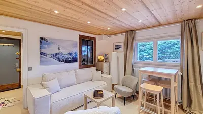 a living room with a couch and a table at 1 Farniente in Megève