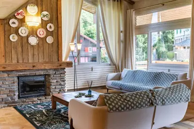 a living room with a couch and a fireplace at Apt Elegant with balcony 5P 2BR Megève Center in Megève