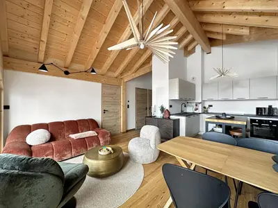 a living room with a couch and a table at DBA302 Appartement standing 6 pers in Les Carroz d'Araches