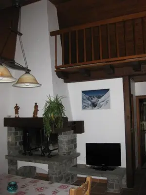 a living room with a fireplace and a television at Appartement Léa in Chamonix-Mont-Blanc