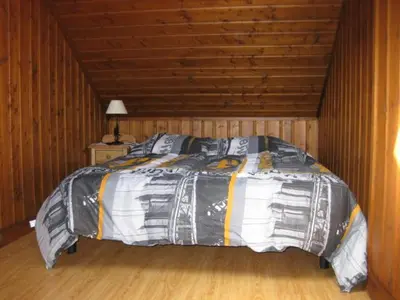 a bedroom with a bed in a wooden room at Appartement Léa in Chamonix-Mont-Blanc